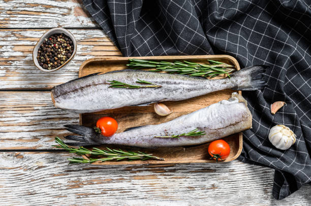 istock Fresh Pollock fish. Raw seafood. White wooden background. Top view 1227331948