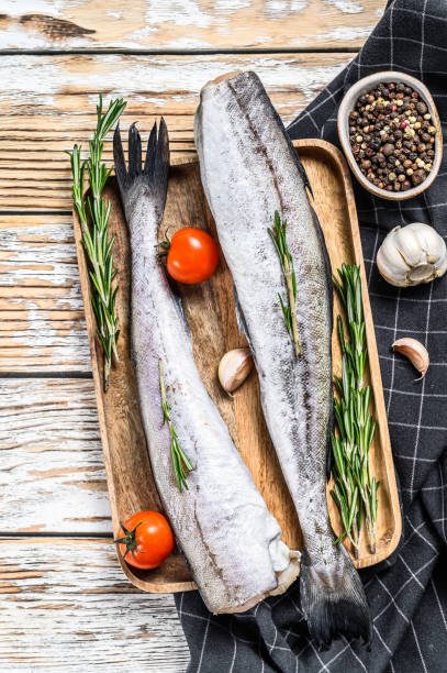 istock Whole fish Pollock. Raw seafood. White background. Top view 1227332109