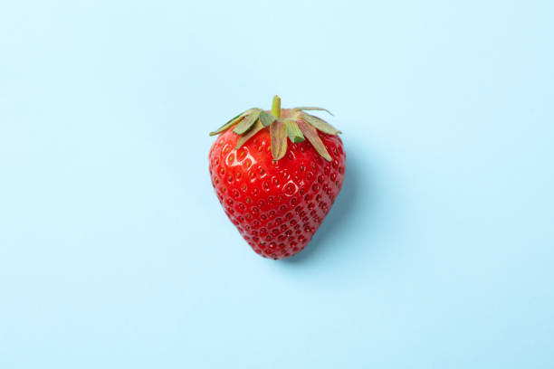 istock Tasty strawberry on blue background. Summer berry 1227332546