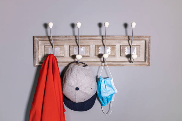 istock Coat rack with a jacket, a cap and a safety mask. 1227333283