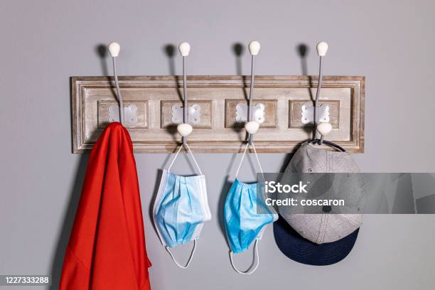 Coat Rack With A Jacket A Cap And A Pair Of Safety Mask Stock Photo - Download Image Now