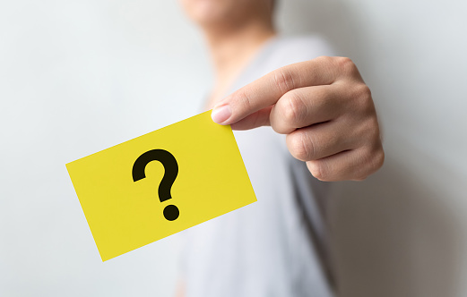 Man holding yellow card with question mark symbol