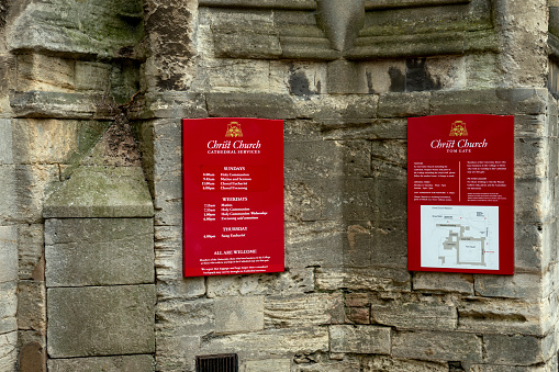 Christ Church Cathedral entrance with signs giving opening hours and hours of service, Oxford England, UK.