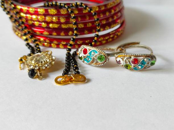 istock Necklace and bangles on plain background. Bangles and necklace on white background. Mangalsutra and bangles traditional ornaments. Red bangles and mangalsutra. 1227334357