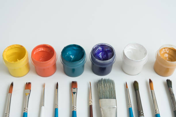 istock Open jars with gouache and paint brushes of different sizes. The view from the top. Background, texture. The concept of space for creativity and choice. 1227335262