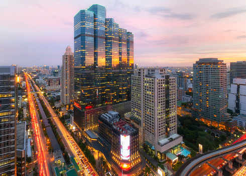 View of Sathorn district, Bangkok downtown skyline, financial district and business in Thailand with skyscraper and high-rise buildings at sunset.