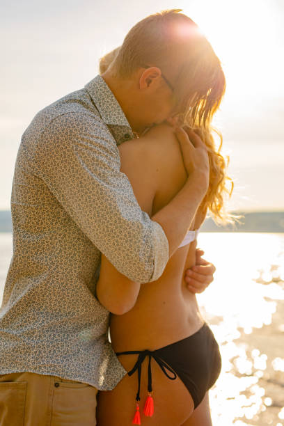istock Caring man embrace beautiful girlfriend at the beach 1227335645