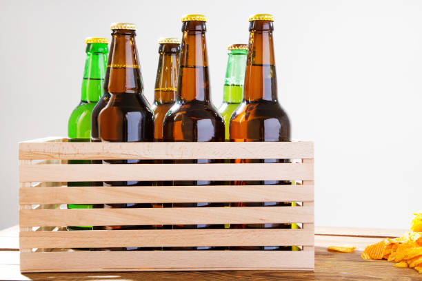 istock Beer bottles in wooden box. corrugated golden chips. Top view. Selective focus. Mock up. Copy space.Template. Blank. 1227336442