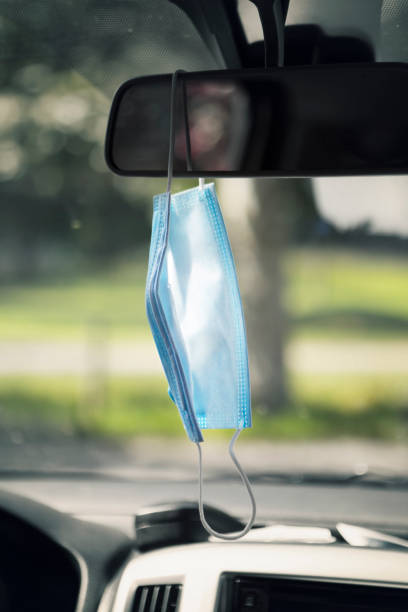 istock Face mask hanging on the rear-view mirror 1227336500