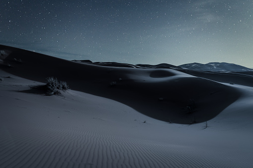 Dunes and starry sky in Sahara desert. Night in the desert.