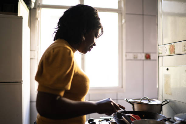 istock Woman cooking at home 1227340564