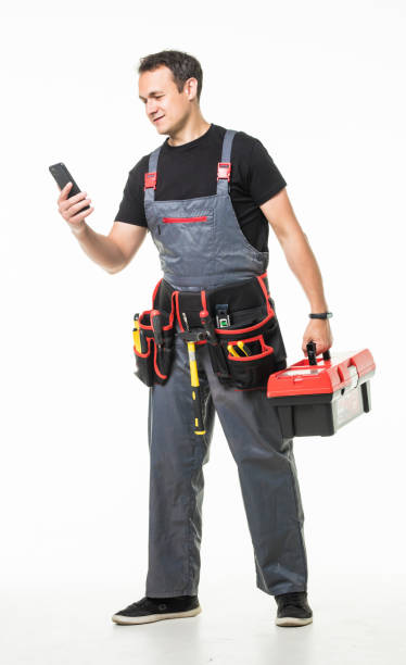 istock Repair, construction and building. Male worker or builder with smartphone and working tools on belt and box over grey background 1227340895
