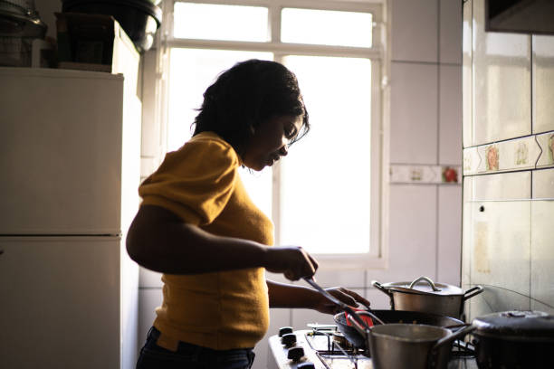 istock Woman cooking at home 1227340917