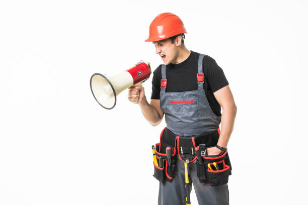 istock Full length of worker speaking into megaphone isolated over white background 1227341022
