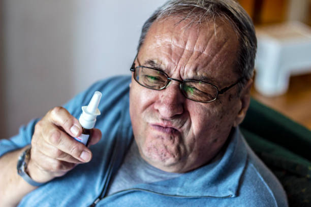 istock Senior man with nasal spray. 1227341430