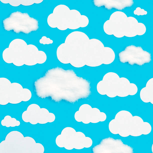 istock A pattern of cut-out white clouds on a blue background. 1227343443