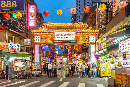 Taipei, Taiwan - March 29, 2020 : night view of the entrance of Raohe Street Night Market, one of the oldest and most famous night markets in Taipei, Taiwan.
