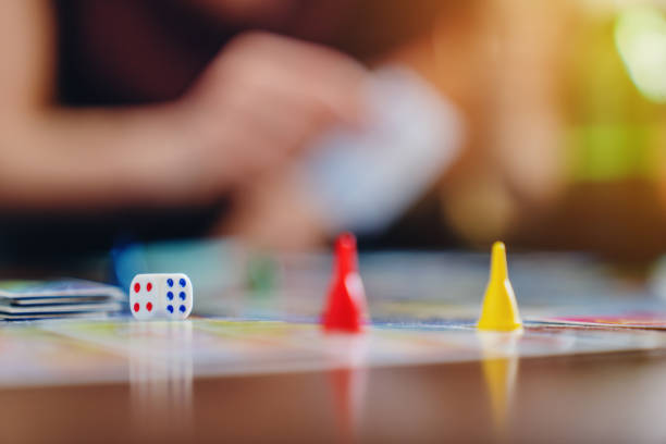 istock Board game concept- friends spend time together. Board game field, figures, dice. 1227346847