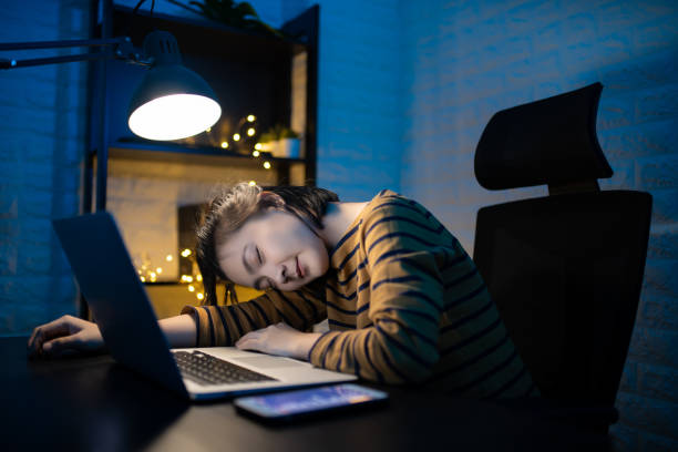 istock Asian woman tired and take a nap after overwork overtime at home. WFH. Work from home for avoid the Coronavirus COVID 19 concept. 1227348371