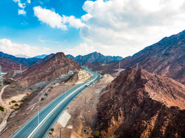 istock Desert road through Hajar mountain range stretching through UAE 1227348586