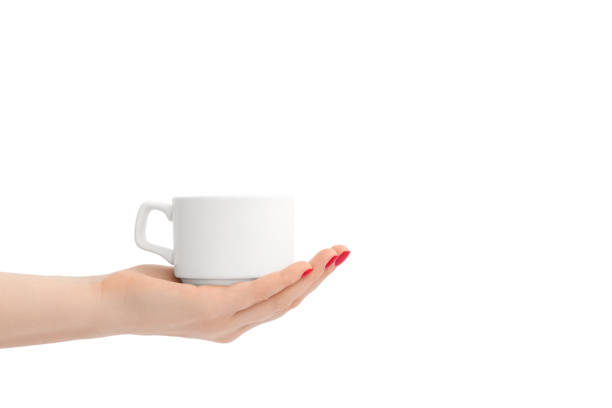 istock White ceramic cup in a female hand with red nail polish. 1227349564