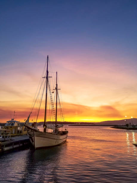 Moored sailboat in Vilanova der Ãrousa harbor at golden dusk