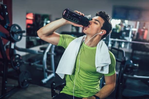 istock Handsome sporty man resting, having break drinking water after doing exercise 1227351330