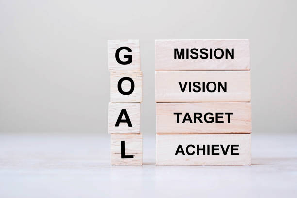 istock GOAL text wooden cube with Mission, Vision, Target and Achieve blocks on table background. Business concept 1227351391