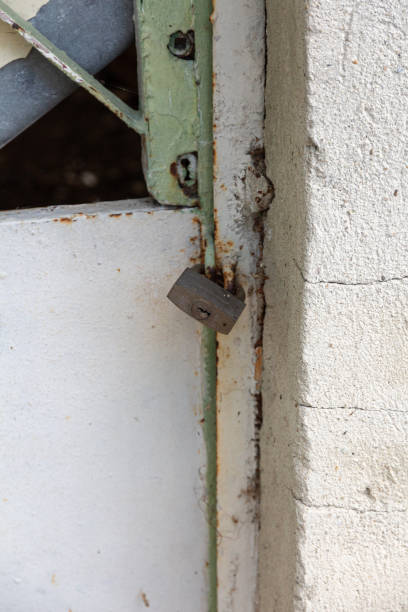 istock padlock on an iron door in a old concrete wall 1227354197
