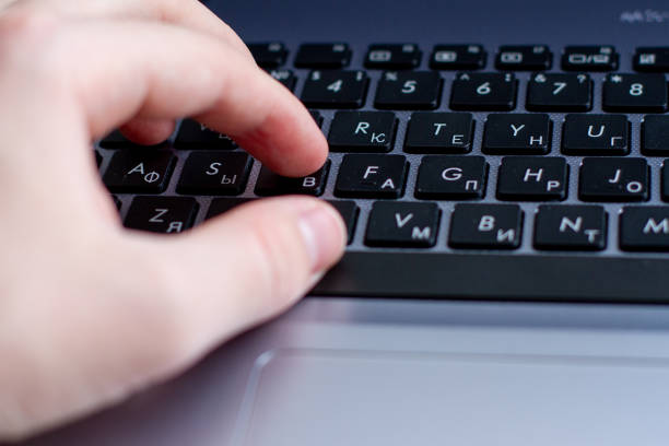 istock hand typing on silver laptop keyboard, close up 1227354300
