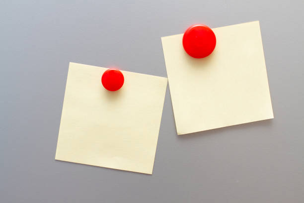 istock Sheet of paper with magnets on fridge. Space for text. mock up 1227355078