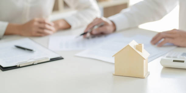 istock Real estate agent and customer with house sign contract. 1227355119