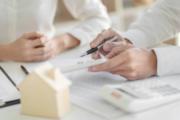 istock Real estate agent and customer with house sign contract. 1227355124