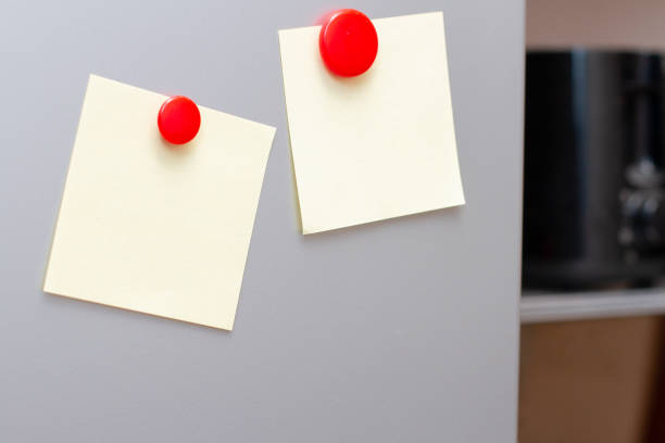 istock Sheets of paper with magnets on fridge kitchen. Space for text. 1227355332