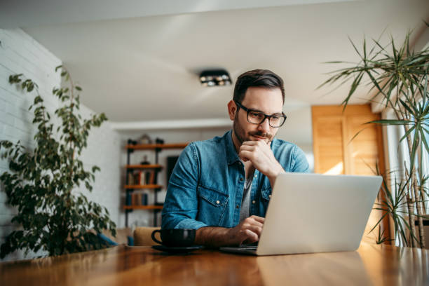 istock Portrait of a handsome man using laptop at home. 1227355407