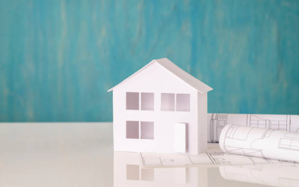 istock House with building plans against a background in turquoise 1227355645