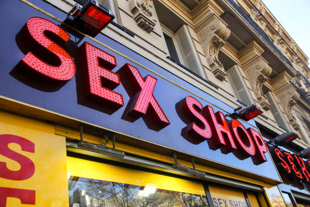 Sex shop Sex shop sign on a street in Pigalle, quarter famous for its neon-lit red light district and eclectic nightlife in Paris, France. place pigalle stock pictures, royalty-free photos & images