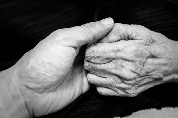 istock Old woman holding his son's hand 1227357205