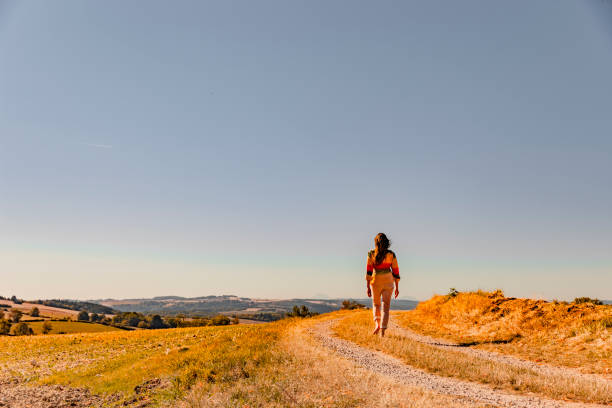 istock Woman runs barefoot on footpath 1227357873