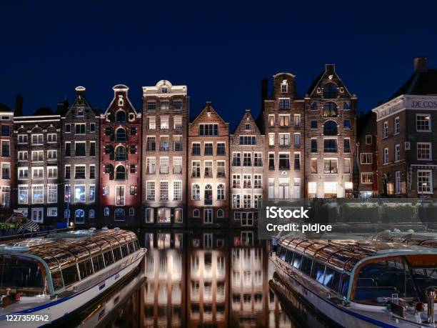 Amsterdam Skyline Old Buildings Waterfront Damrak Stock Photo - Download Image Now - Amsterdam, Night, Urban Skyline