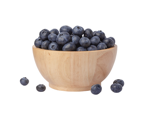 Blueberries in wooden bowl isolated on white background
