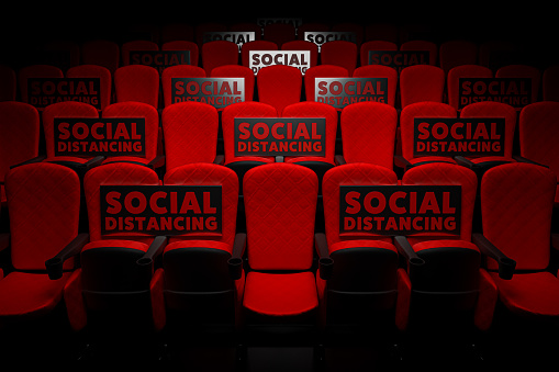 3d rendering the row of red cinema seats in the empty theater auditorium with the banner social distancing for against pandemics of COVID-19 concept.