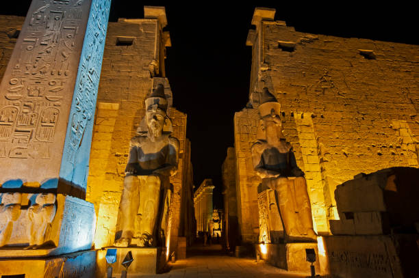 istock Statue and hieroglyphic carvings at an ancient egyptian temple in night 1227361217