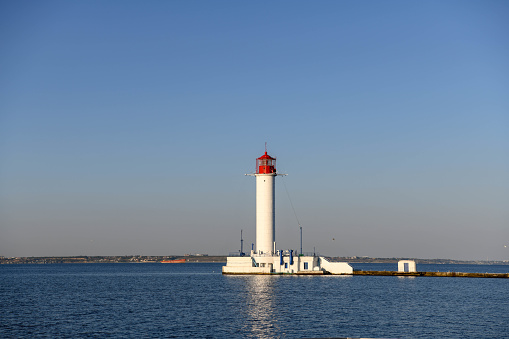 Europe, Ukraine, Odessa. The lighthouse of the port of Odessa illuminated by the setting sun.