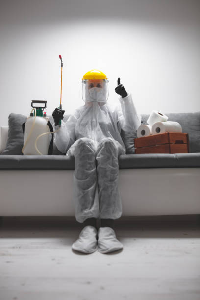 Scientist with protective suit and face mask, bio hazard sprayer for decontamination agaist viruses, germs - toilet paper stock paranoia at home, waiting for end of days. Scientist with protective suit and face mask, bio hazard sprayer for decontamination agaist viruses, germs - toilet paper stock paranoia at home, waiting for end of days. biohazard cleanup stock pictures, royalty-free photos & images