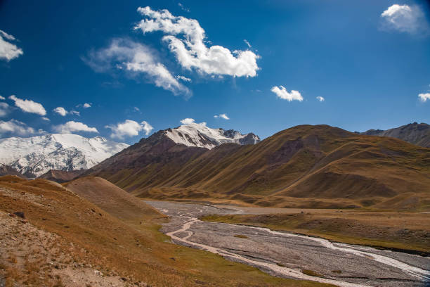 istock Beautiful mountainious landscape. Snowy mountain peaks. Hilly valley. 1227367436