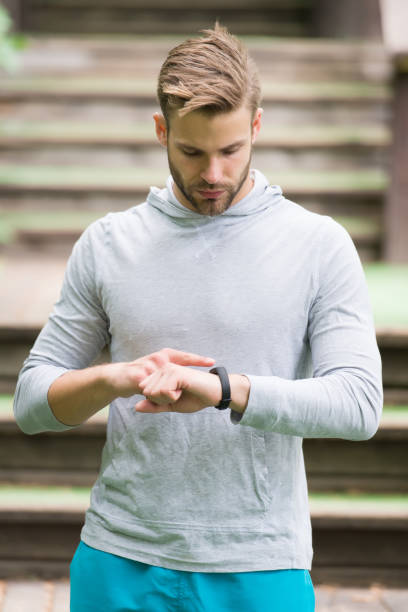 istock Monitoring heart rate from your wrist. Athletic man check watch. Handsome athlete use smart watch. Fitness tracking. Track distance and steps with watch. Workout tracker and watch. Sports tech 1227368142
