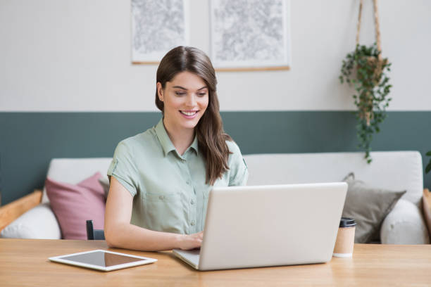istock Young woman student using laptop at home. 1227370186