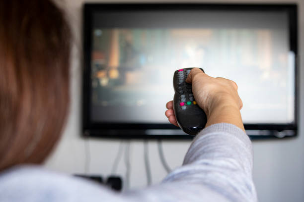 istock Woman watching tv at home 1227370597