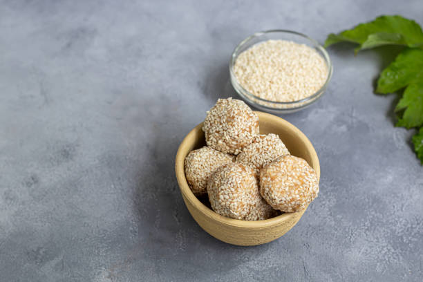 istock Energy bites without baking are made from ingredients - nuts, cocoa, chocolate, oats and sesame seeds. Located on a gray background. 1227371984